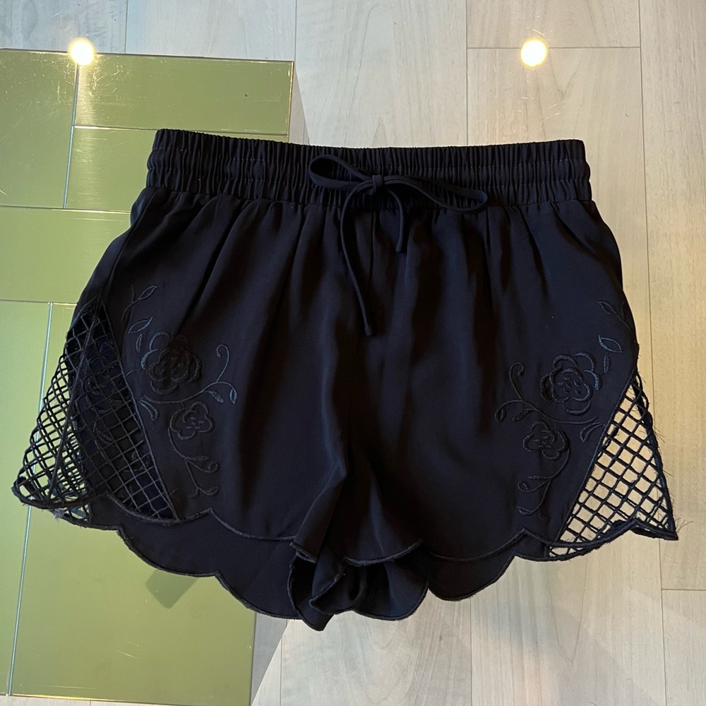 Drawstring high wasted Black shorts with netted and floral embellishes front